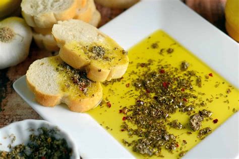 Close up of Copycat Carrabba's Olive Oil Bread Dip on a white plate | Olive oil dip for bread ...