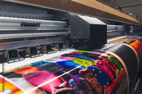 Large format printing machine in operation. Industry Stock Photo | Adobe Stock