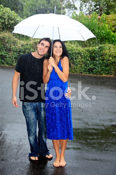 Young Couple With Umbrella Standing In The Rain. Stock Photo | Royalty-Free | FreeImages