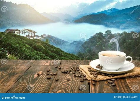 Morning Cup of Coffee and Coffee Beans with Mountain Background at Sunrise. Beauty Mountain ...