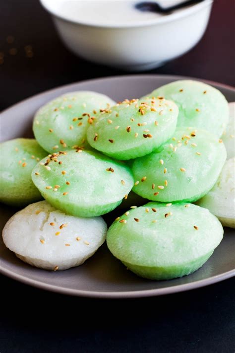 green and white desserts on a plate with a bowl in the background at a ...