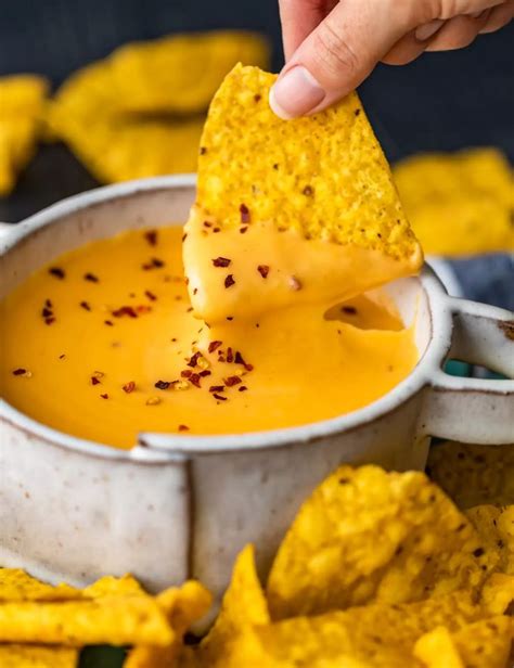 dipping a tortilla chip into a bowl of nacho cheese sauce | Cheese sauce recipe, Nacho cheese ...