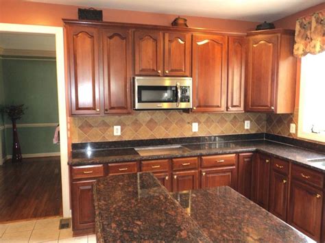 Tan Brown Granite Kitchen Countertop of Kitchen Island with Freestand Wooden Cabinet and Nice Ti ...