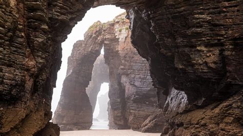 Natural rock arches on Cathedrals beach in low tide, Praia As Catedrais, Ribadeo, Spain ...