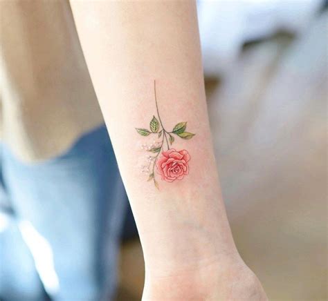 a small rose tattoo on the wrist