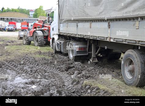 Heavy Recovery Tractor Pulling Semi Truck Stuck in Mud Stock Photo - Alamy