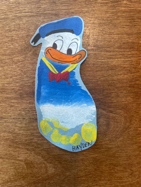 Donald Duck footprint art | Footprint art, Baby art, Duck crafts