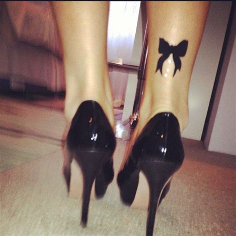 Black bow tattoo