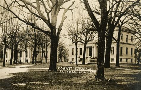 Elkhorn County Buildings Through Trees | Photograph | Wisconsin Historical Society