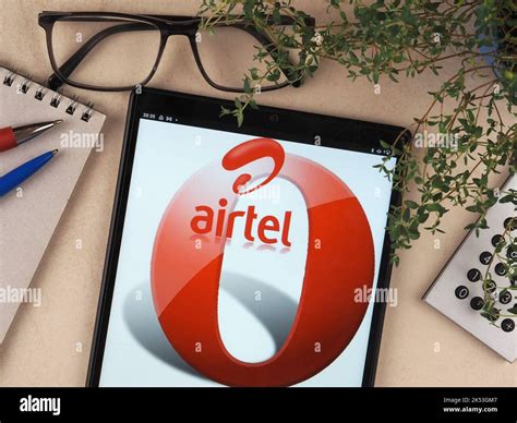 In this photo illustration, Bharti Airtel Limited logo seen displayed on a tablet Stock Photo ...