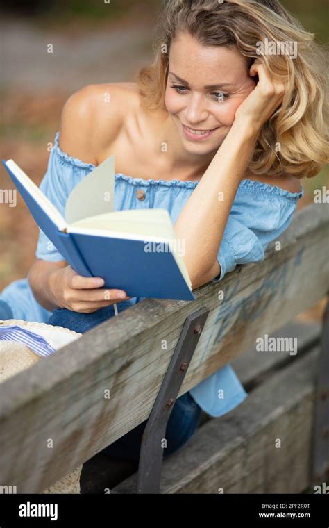 girl sitting on bench in park and reading book Stock Photo - Alamy