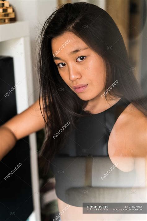 Young adult chinese woman looking at the camera — beautiful, asian - Stock Photo | #214589454