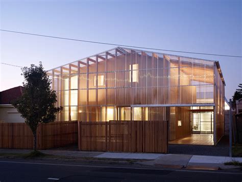 a large wooden building sitting on the side of a road