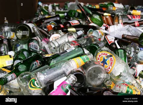 Empty soft drink and alcohol bottles in a skip for recycling outside ...