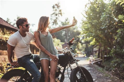 Couple enjoying motorcycle ride on village road – Jacob Lund ...