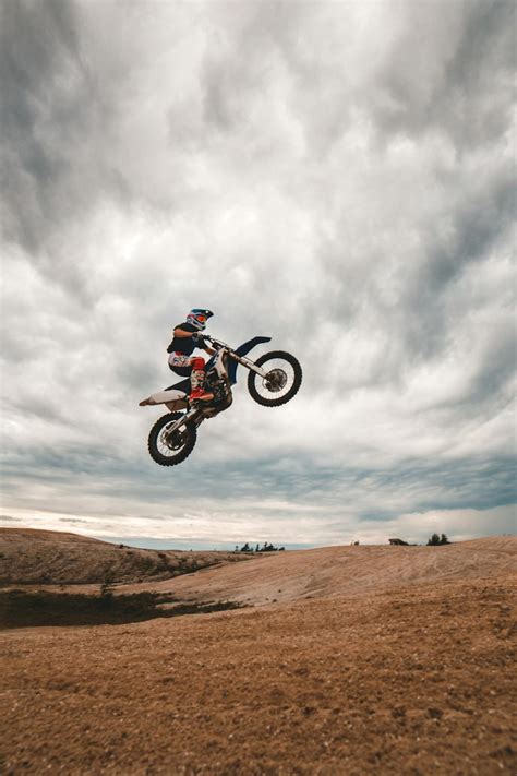 Anonymous man doing stunt on bike · Free Stock Photo