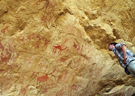 The Ennedi Massif, members of the expedition in front of prehistoric rock art, Explore Chad ...