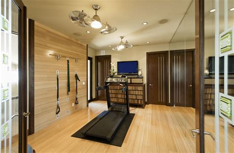 Beautiful home gym/yoga-space, featuring bamboo flooring and walls, mirrored accent walls, and ...