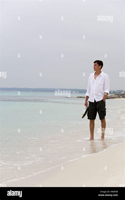 Man, barefoot, walk, beach, Formentera, the Balearic Islands Stock Photo - Alamy