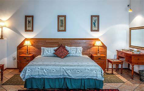 Royalty-Free photo: Brown wooden bed with green and white floral ...