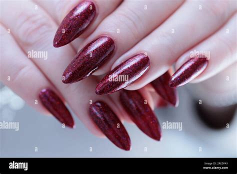 Female hands with long nails and dark black red nail polish Stock Photo ...
