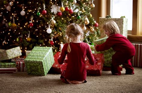 Two Children Opening Gifts On Christmas Morning