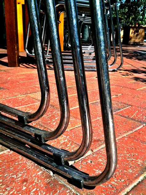 Shiny Stack | Shiny metal legs on a stack of cafe chairs, ou… | Flickr