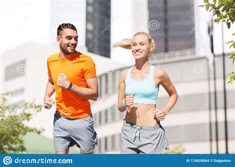 Happy Couple with Fitness Trackers Running at City Stock Photo - Image ...