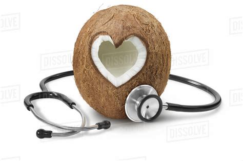 A heart shape cut into a coconut with a stethoscope - Stock Photo ...