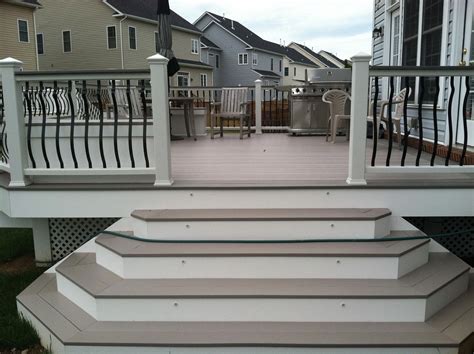 An AZEK deck with Trex railings with Baroque balusters. Lighting is low voltage LED lighting. De ...