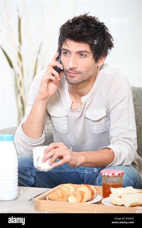 Man making a phone call over breakfast Stock Photo - Alamy