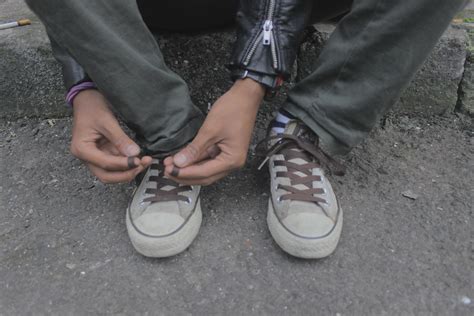 someone tying shoelaces 3601074 Stock Photo at Vecteezy