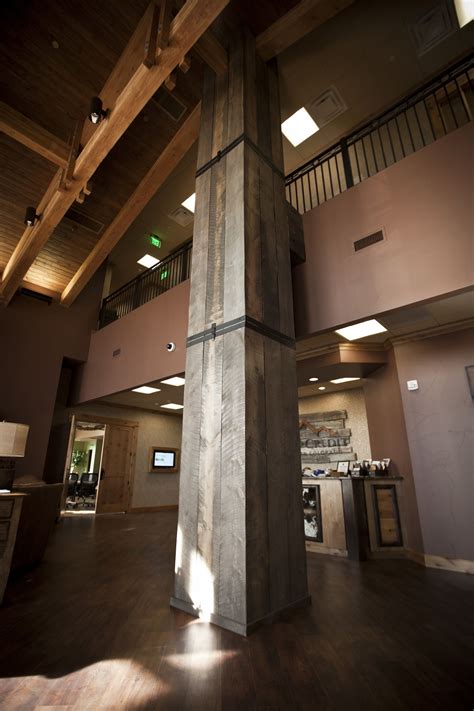 We wrapped a 30' tall column in the lobby with reclaimed wood & metal strap accents! twenty1five ...