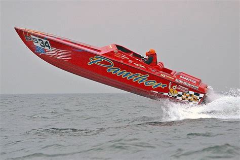 a red speed boat is in the water