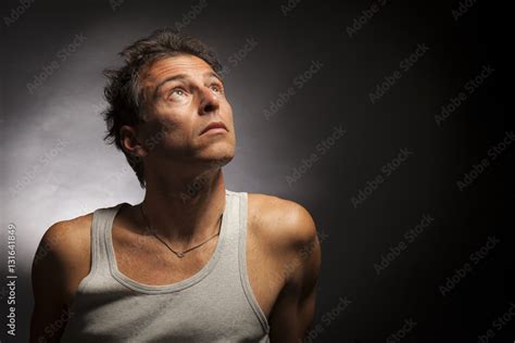 Isolated thinking man face looking up. Low key , studio portrait, black background. Stock Photo ...