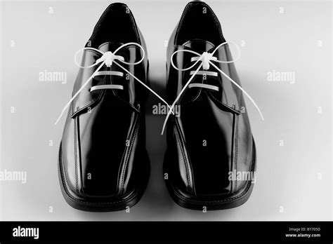 black men's dress shoes white laces on white background Stock Photo - Alamy