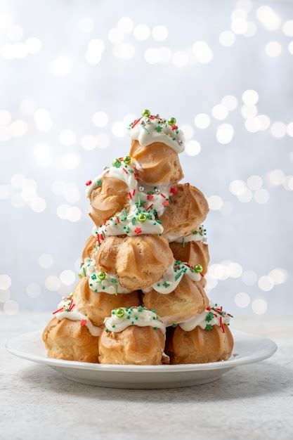 Premium Photo | Croquembouche with holly berry decoration for christmas