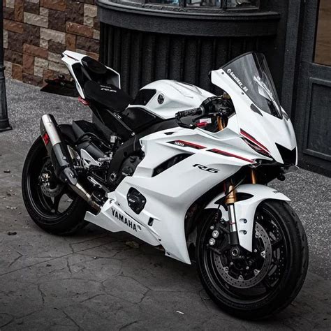 a white and black motorcycle parked on the street