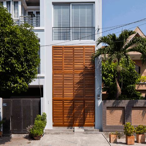 Vietnamese shophouse by MM++ Architects features a facade that folds open Facade Design, House ...
