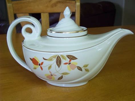 a white tea pot sitting on top of a wooden table