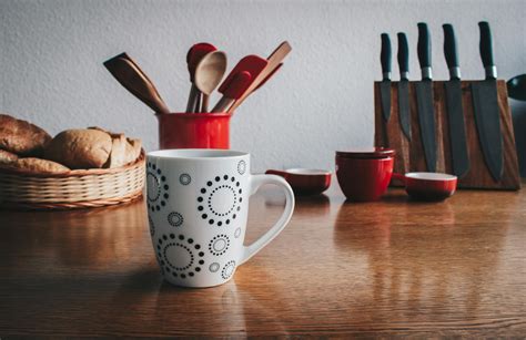 Mug in Front of Breads Beside Spatulas on Table · Free Stock Photo