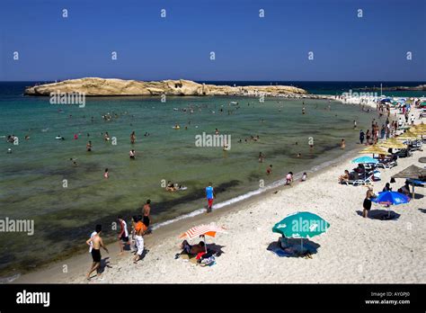 Holidaymakers swim and cool off Monastir Beach Tunisia Stock Photo - Alamy