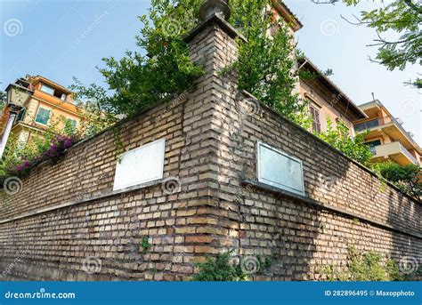 Corner of the Brick Fence with Green Bushes and Flowers Stock Image ...