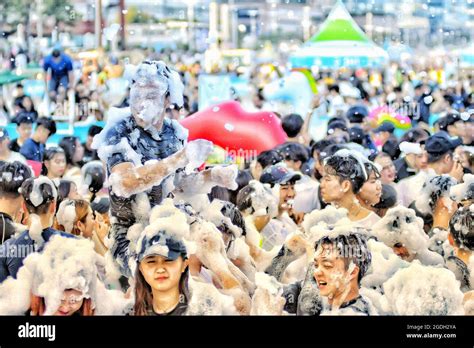 BUSA, KOREA, SOUTH - Aug 04, 2020: A group of cheerful people covered in foam during the Busan ...