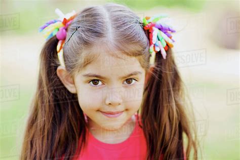 Portrait of cute little girl with two ponytails outdoors - Stock Photo ...