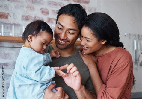 Family with down syndrome baby, happy parents in kitchen home together and young child care ...