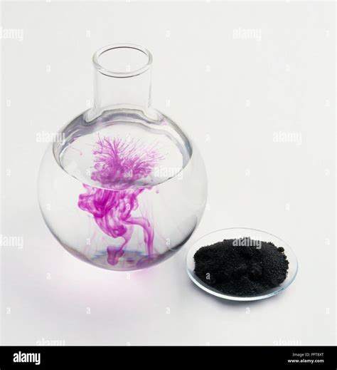 Potassium permanganate crystals dissolving in water Stock Photo - Alamy