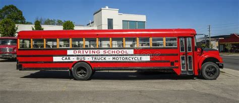 Red driving school bus editorial stock image. Image of field - 187323999