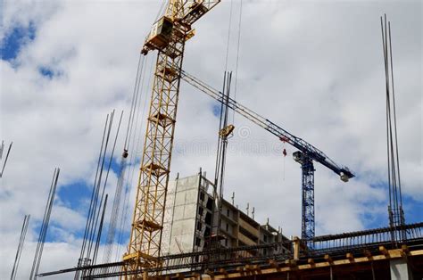 Two Construction Cranes Are Building A High-rise Building Stock Image ...