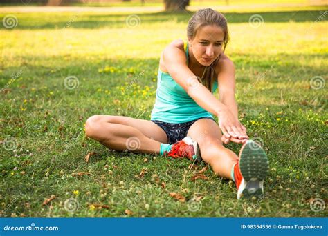 Young Sport Woman Doing Exercises during Training Outside in City Park. Fitness Model Running ...